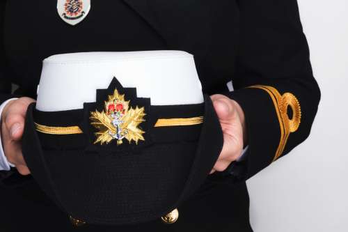 Hands Holding A Navy Peaked Cap Photo