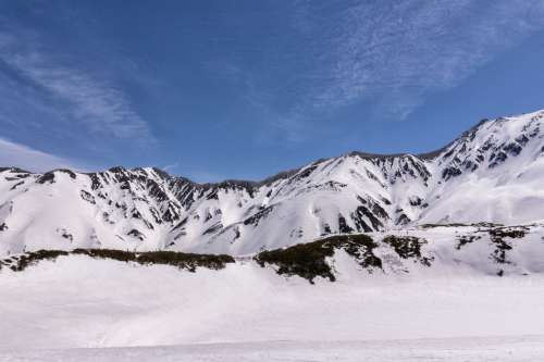 Hikers Traversing Snowy Mountain Trail Photo