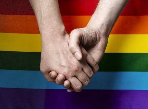 Holding Hands With Pride Flag Photo