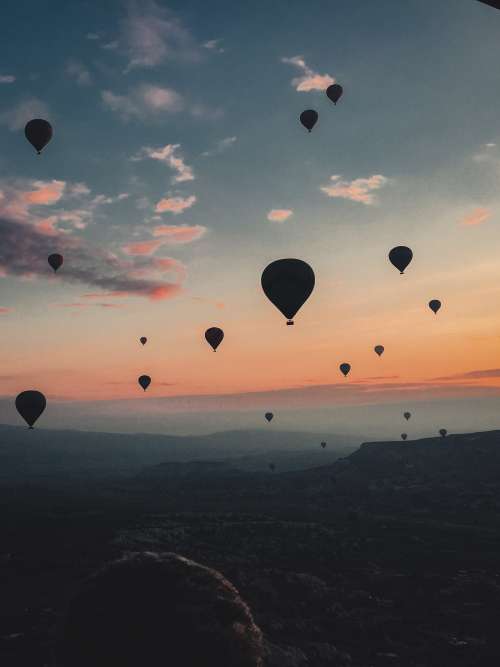 Hot Air Balloons Floating Into The Sunset Photo
