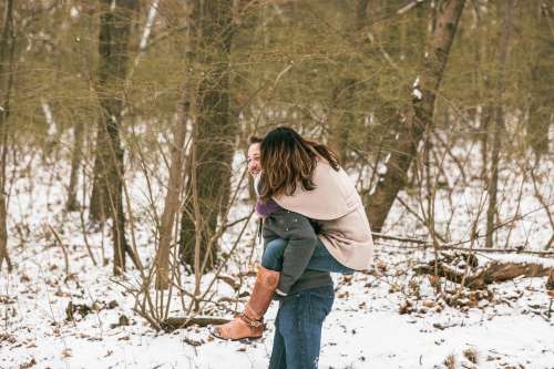 Man Carries His Girlfriend On His Back Threw The Snow Photo