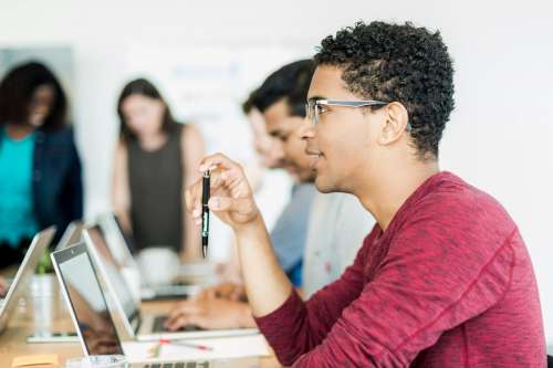 Man Holding Pen In Meeting Photo