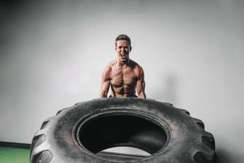 Man Lifts Tire Exercise Photo