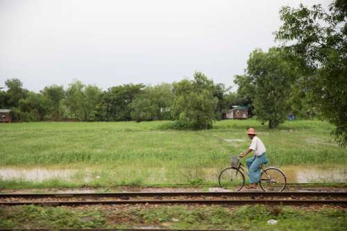 Man On Bike Near Tracks Photo