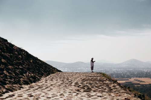 Man Prays On Stone Temple Ledge Photo