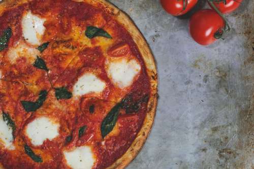 Margarita Pizza And Fresh Tomatos Photo