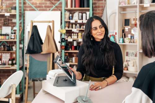 Merchant Showing Customer Pos Ipad Photo