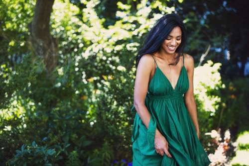 Model Smiles And Walks In Green Dress Photo