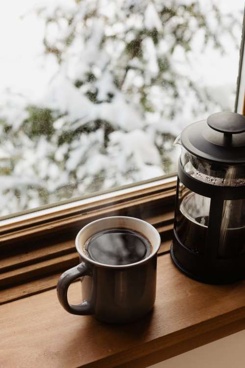 Mug Of Coffee And A French Press On A Window Sill Photo