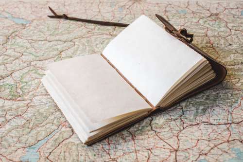 Open Notebook On World Map Photo