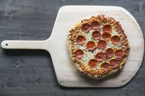 Pepperoni Pizza On Wood Board Photo