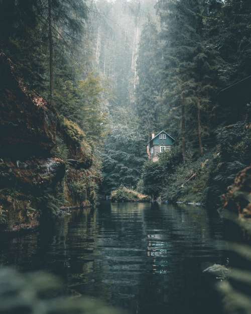 Remote Log Cabin On Calm Forest River Photo