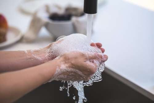 Rinsing Soapy Hands In Water Photo
