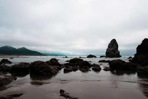 Rocky Shore And Low Clouds Photo