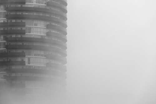 Round Skyscraper In Fog Photo