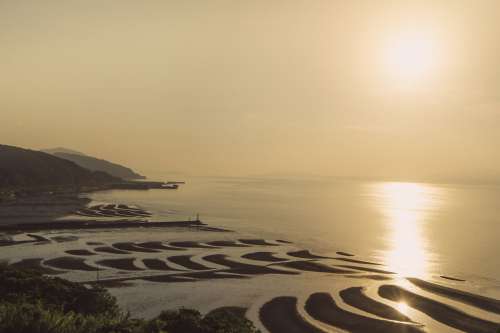 Sand Bars From Low Tide By Shore At Sunset Photo