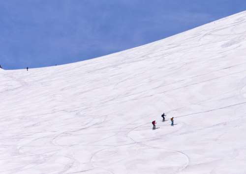 Skiers Making Their Way Across A Slope Photo