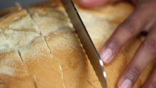 Slicing Fresh Bread Photo