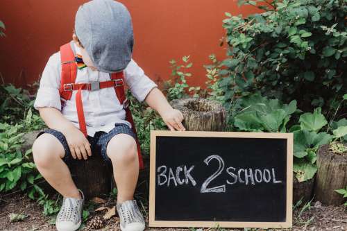 Small Child With Back To School Sign Photo