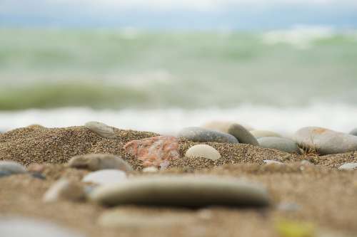 Smooth Rocks On Sandy Beach Photo