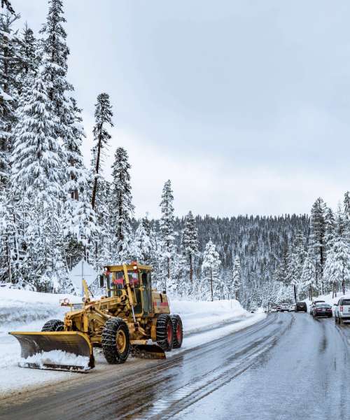 Snow Plough On Forest Road Photo