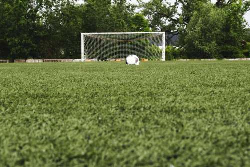 Soccer Ball In Field With Net Photo