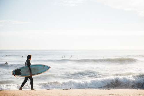Surfer Carrying Board Photo