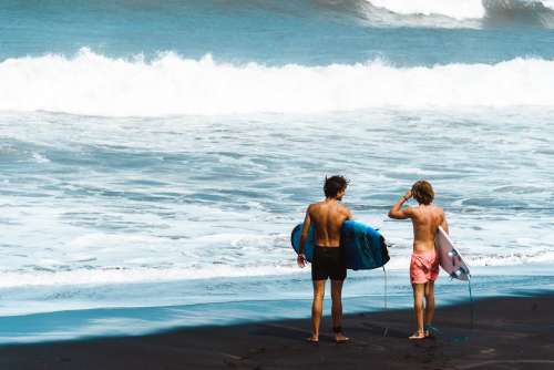 Surfers Stand On Shore Photo