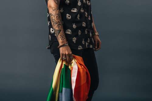 Tattoos Bracelets And Rings Holding Pride Flag Photo