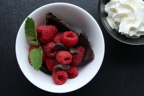 Top View Of Raspberries Chocolate And Mint In White Dish Photo