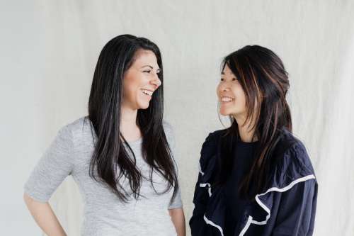 Two Women Beam Smiles At Each Other Photo