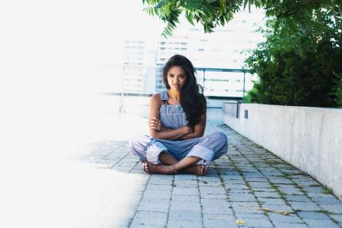 Woman Crosses Arms And Legs With Angry Face Photo