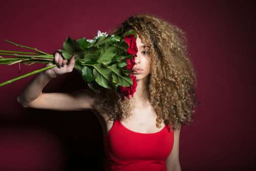 Woman Grasping Flowers Photo