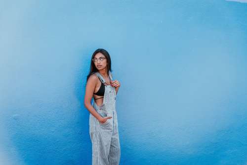 Woman In Front Of Blue Wall Looking Back Photo