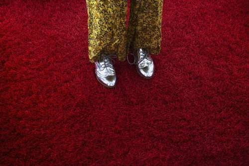 Woman In Silver Oxfords Crossing Red Shag Carpet Photo