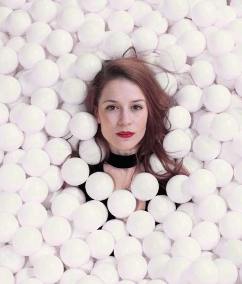 Woman Is Completely Covered In White Styrofoam Balls Photo