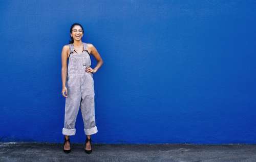 Woman Laughing And Posing By Blue Wall Photo