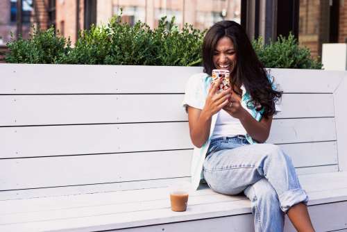 Woman Laughs At Mobile Phone Photo