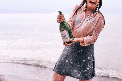 Woman Popping Champagne Photo