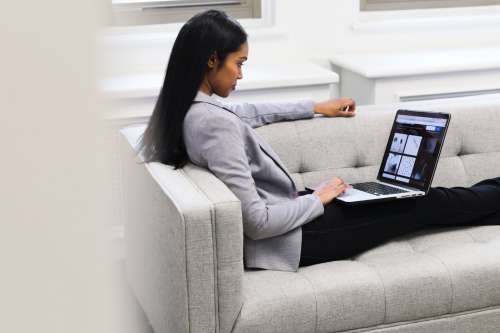 Woman With Laptop On Couch Photo