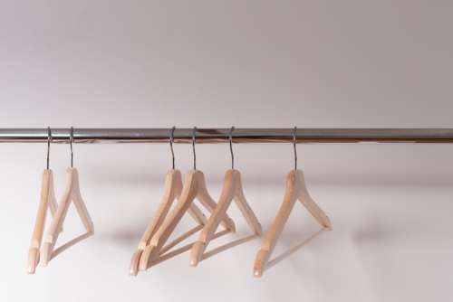 Wooden Clothes Hangers Cling Emptily To The Shiny Shop Rack Photo