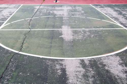 Worn Down Outdoor Basketball Court Photo
