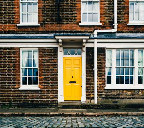 Yellow Door On Brick Home Photo