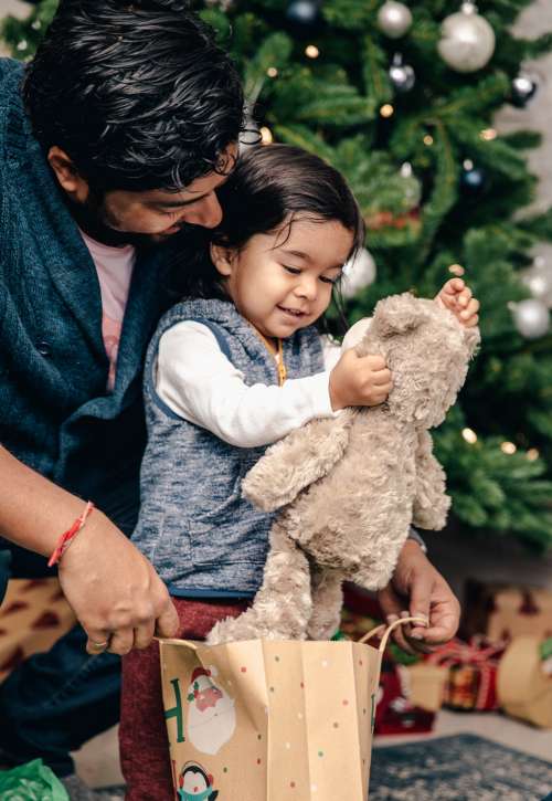 Young Boy Receives Teddy Bear For Christmas Photo