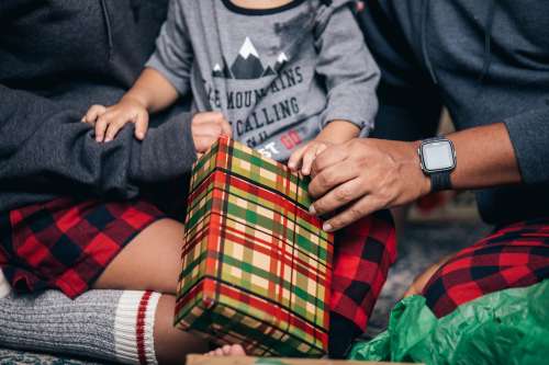 Young Family Opens Christmas Presents Photo