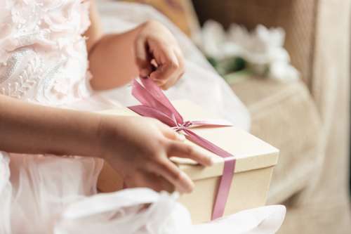 Young Girl Opening Gift Photo