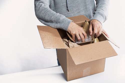 Young Man Preparing A Package For Fulfillment Photo