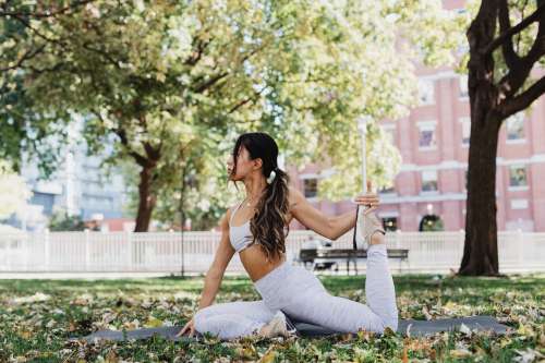 Young Woman Doing Yoga In Park Photo