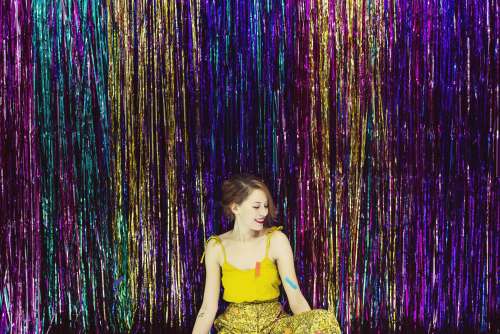 Young Woman In Front Of Shimmering Wall Photo