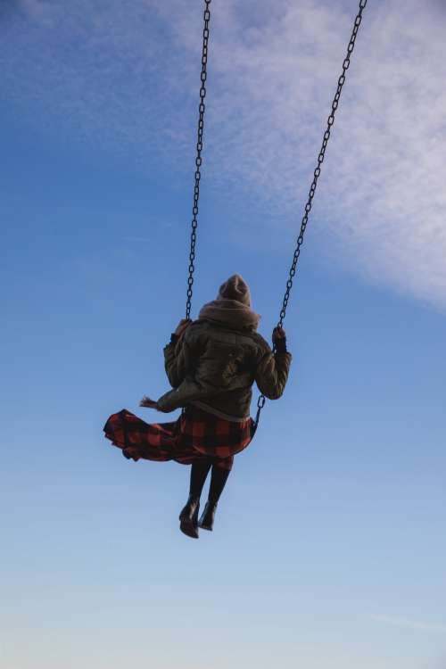 Young Woman On Swing Reaching To Sky Photo